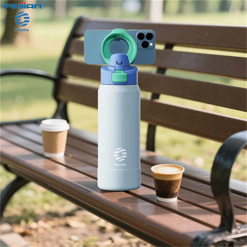 Light blue water bottle with green lid on a wooden bench outdoors