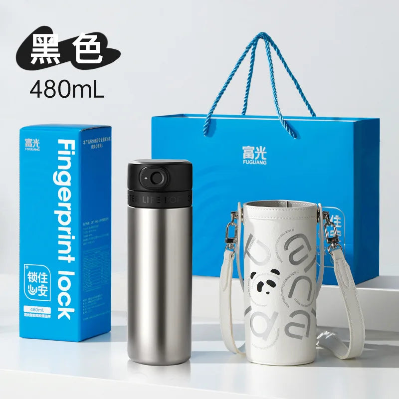 Two stainless steel water bottles with a blue gift bag and packaging on a white background